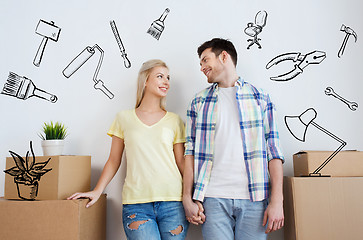 Image showing smiling couple with big boxes moving to new home