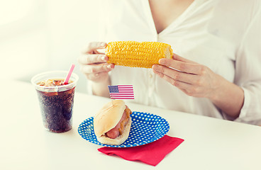 Image showing woman hands holding corn with hot dog and cola