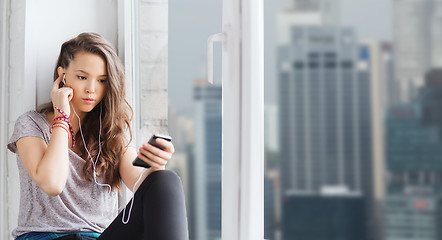 Image showing teenage girl with smartphone and earphones
