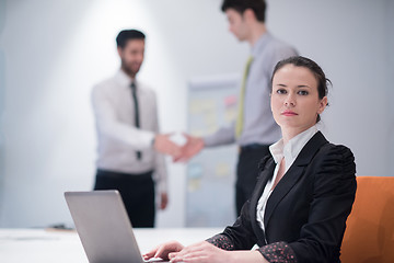 Image showing young business woman on meeting  using laptop computer