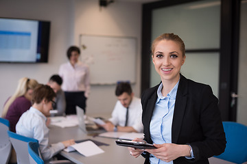 Image showing business woman working on tablet at meeting room