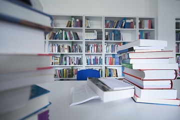 Image showing female student study in library, using tablet and searching for 