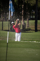 Image showing golfer hitting a sand bunker shot