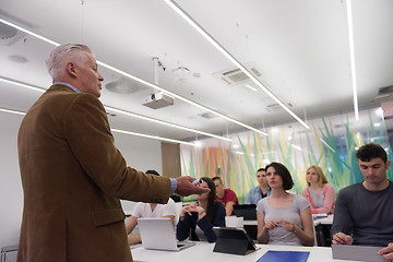 Image showing teacher with a group of students in classroom