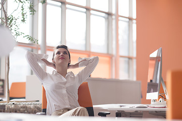 Image showing happy young business woman relaxing and geting insiration