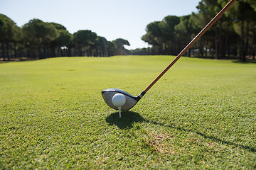 Image showing golf player placing ball on tee