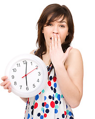 Image showing Young woman is holding big clock