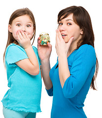 Image showing Little girl and her mother are anxious about time