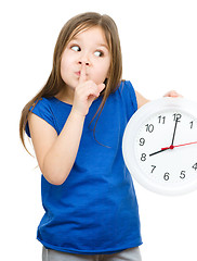 Image showing Little girl is holding big clock