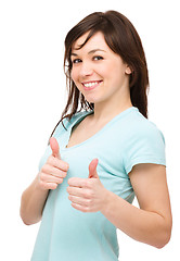 Image showing Woman is showing thumb up gesture