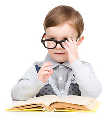 Image showing Little child play with book