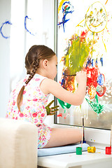 Image showing Portrait of a cute girl playing with paints