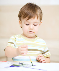 Image showing Little boy is playing with paints