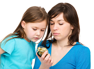 Image showing Little girl and her mother are anxious about time