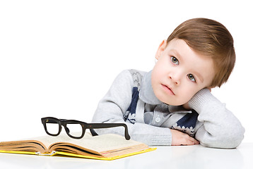 Image showing Little child play with book