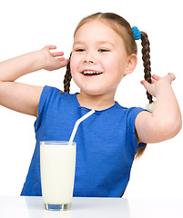 Image showing Cute little girl with a glass of milk