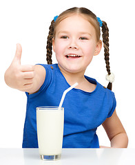 Image showing Cute little girl with a glass of milk