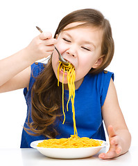 Image showing Little girl is eating spaghetti