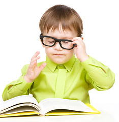 Image showing Little child play with book