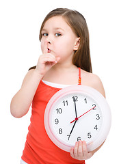 Image showing Little girl is holding big clock