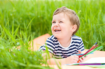 Image showing Little boy is playing with pencils