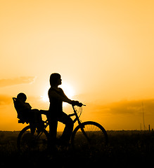 Image showing Mother riding on a bicycle with her child