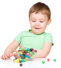 Image showing Portrait of a boy with candies