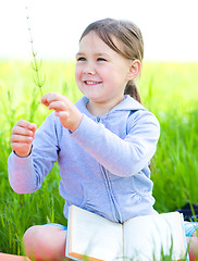 Image showing Little girl is studying plants