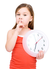 Image showing Little girl is holding big clock