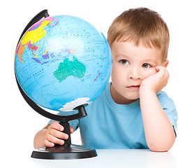 Image showing Little boy with a globe