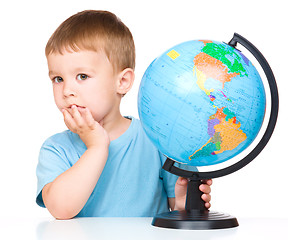 Image showing Little boy with a globe