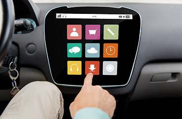 Image showing close up of hand and menu icons on car computer