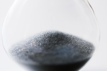 Image showing close up of hourglass with black sand