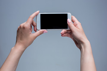 Image showing Closeup shot of a woman typing on mobile phone 