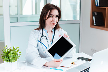 Image showing Woman doctor sitting at the table