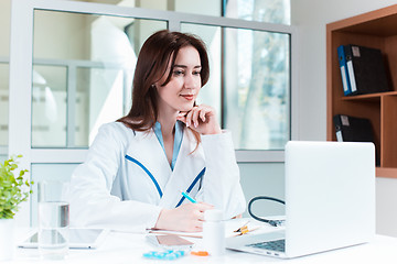 Image showing Woman doctor sitting at the table