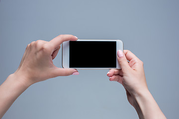 Image showing Closeup shot of a woman typing on mobile phone 