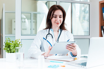 Image showing Woman doctor sitting at the table