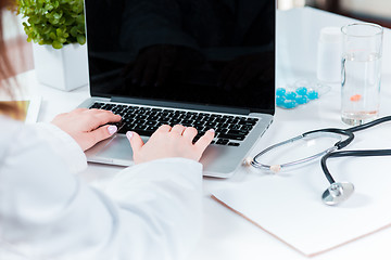 Image showing Doctor working on a digital tablet