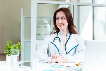 Image showing Woman doctor sitting at the table