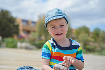 Image showing Happy little boy in multicolored t-shirt