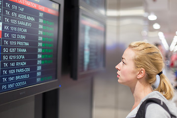 Image showing Passenger looking at flight information board.