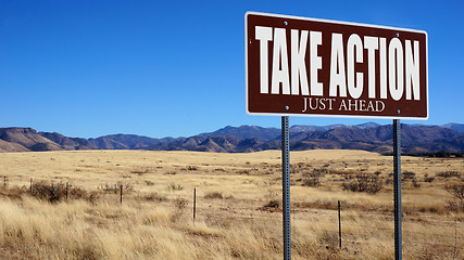 Image showing Take Action Just Ahead brown road sign