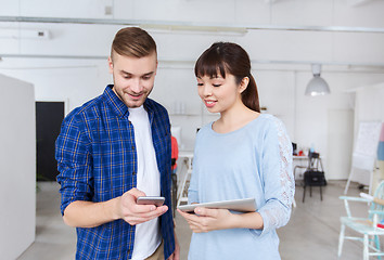 Image showing couple with smartphone and tablet pc at office