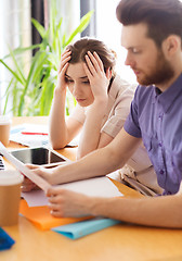 Image showing creative team with reading paper in office