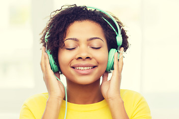 Image showing happy woman with headphones listening to music