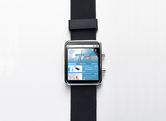 Image showing close up of black smart watch with world news page