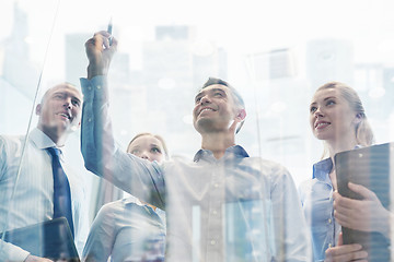 Image showing smiling business people with marker and stickers