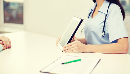 Image showing close up of doctor showing x-ray on tablet pc