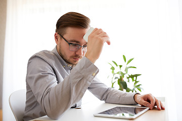 Image showing businessman with smarphone at home office